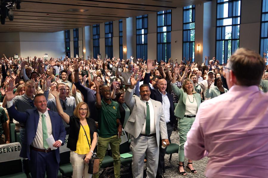 Baylor staff members join in a Sic 'em following the fall staff meeting