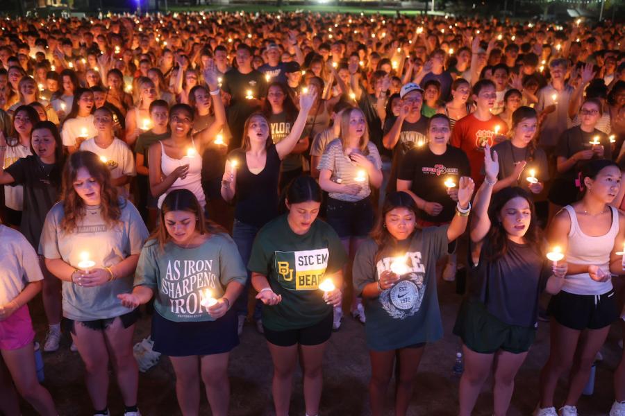 Students participate in a candlight worship service during Welcome Week 2026